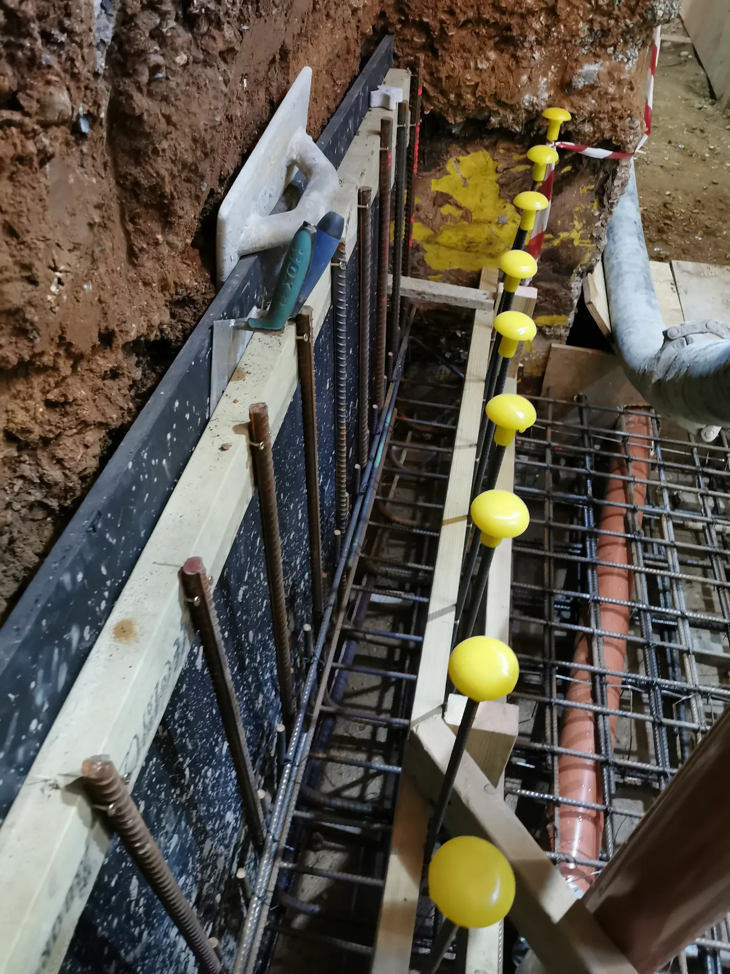 Basement construction in Chiswick displaying steel reinforcement meticulously installed and ready for a concrete pour