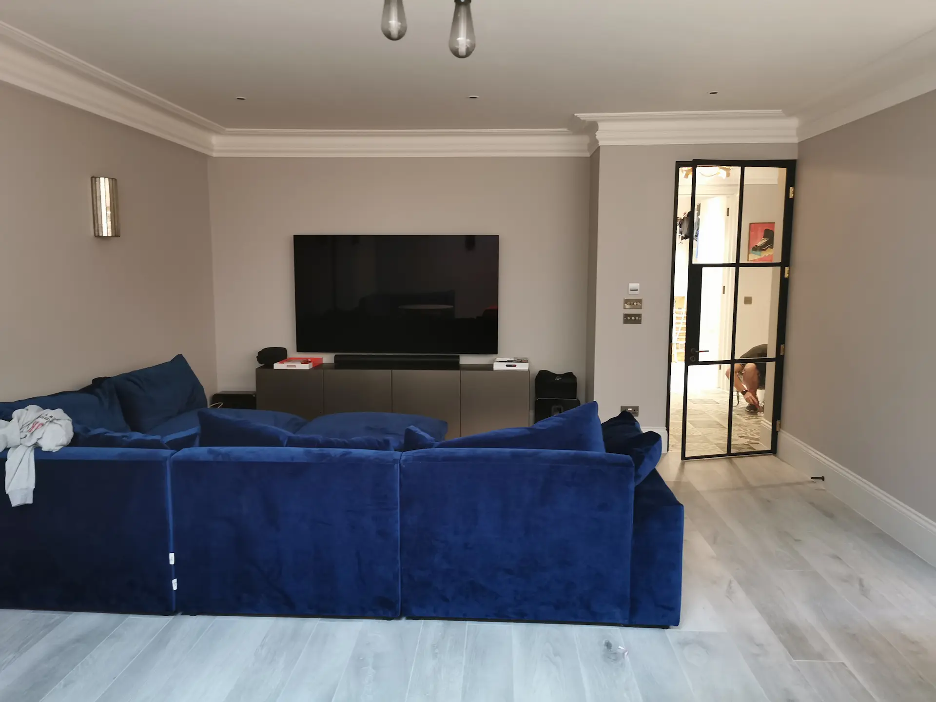 Finished basement cinema room in Chiswick home with Crittall door