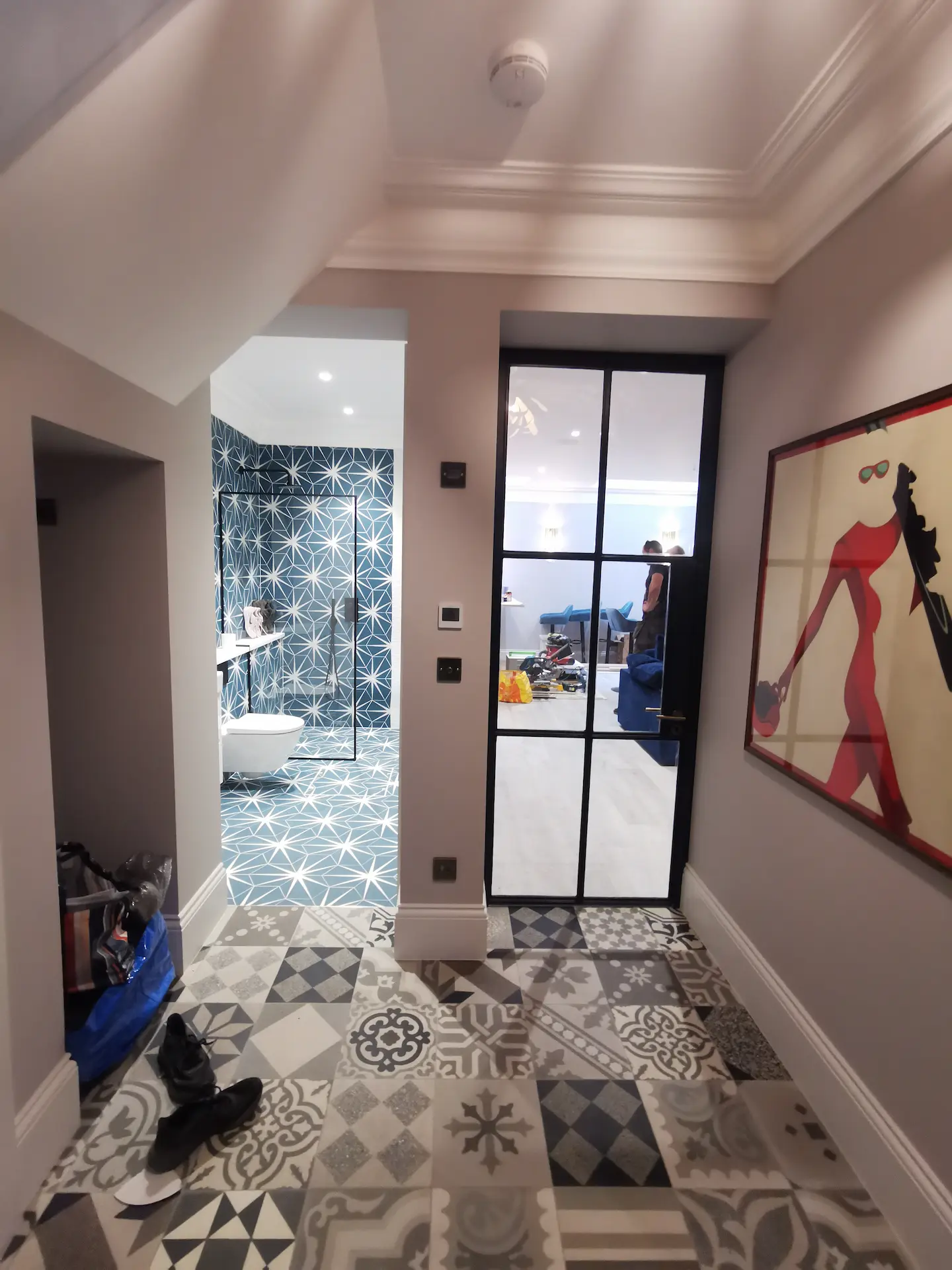 Finished basement hallway in Chiswick home, with entrances to entertainment room and bathroom