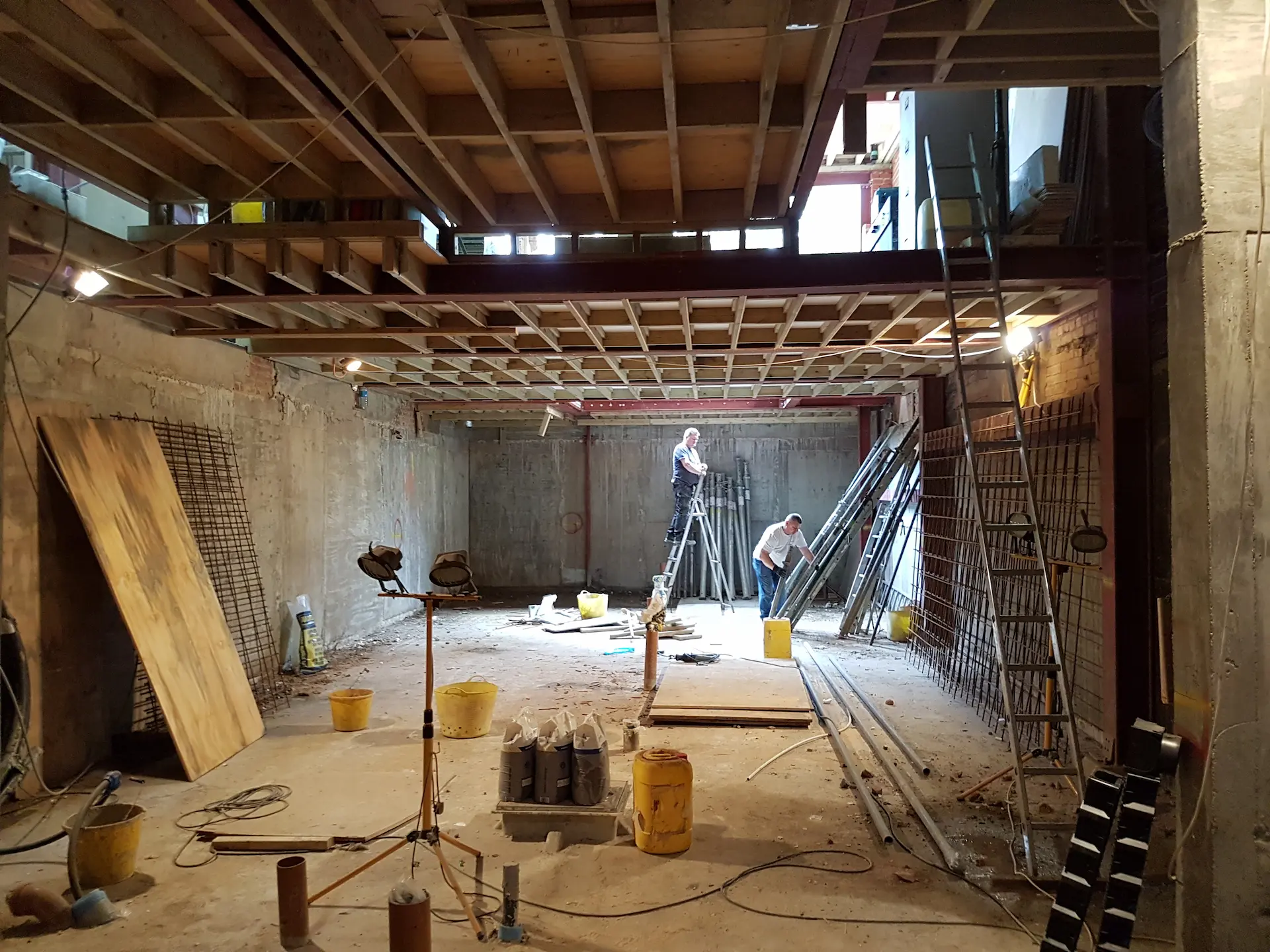 Completed basement shell in Chiswick with steel frames and floor joists, ready for waterproofing
