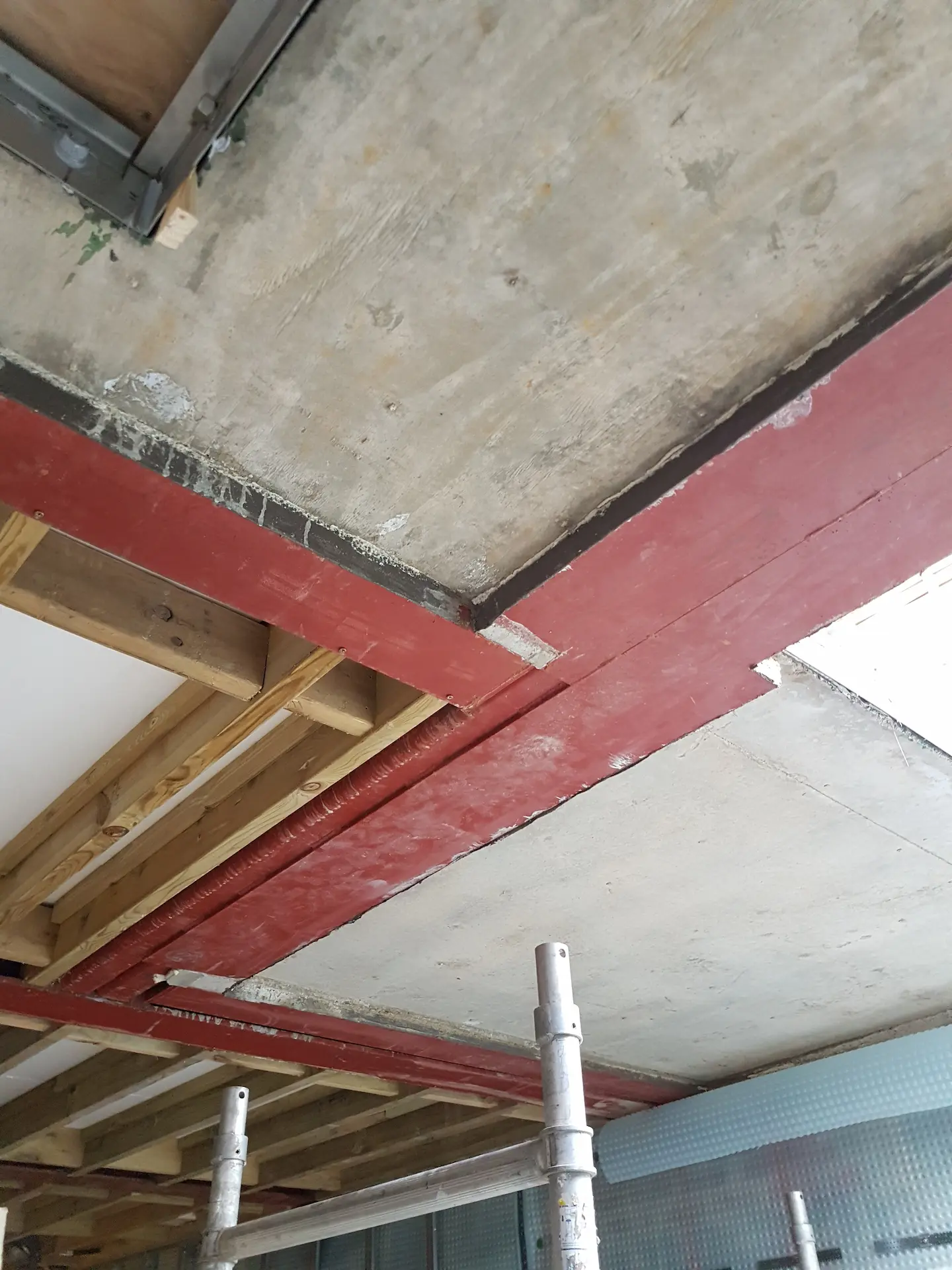 Basement construction in Chiswick showing steel beams, concrete soffit, and floor joists