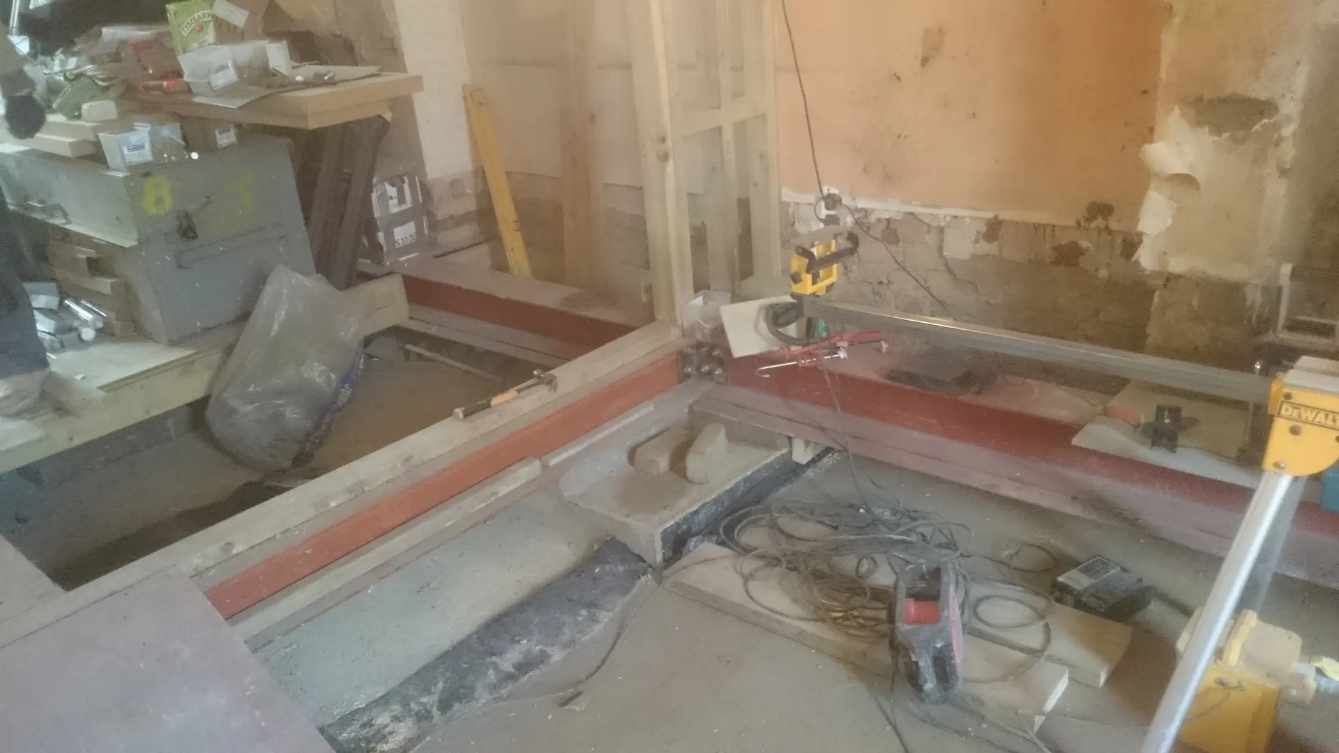 Steel beams being positioned to support the floor structure of a West London house extension in preparation for basement excavation