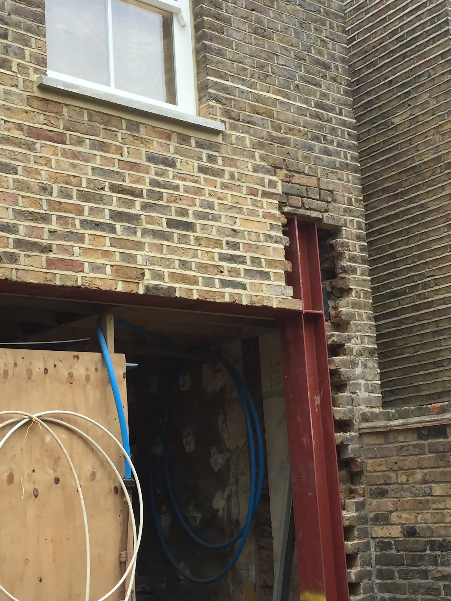 Chiswick house refurbishment with steel frame being covered with London stock bricks