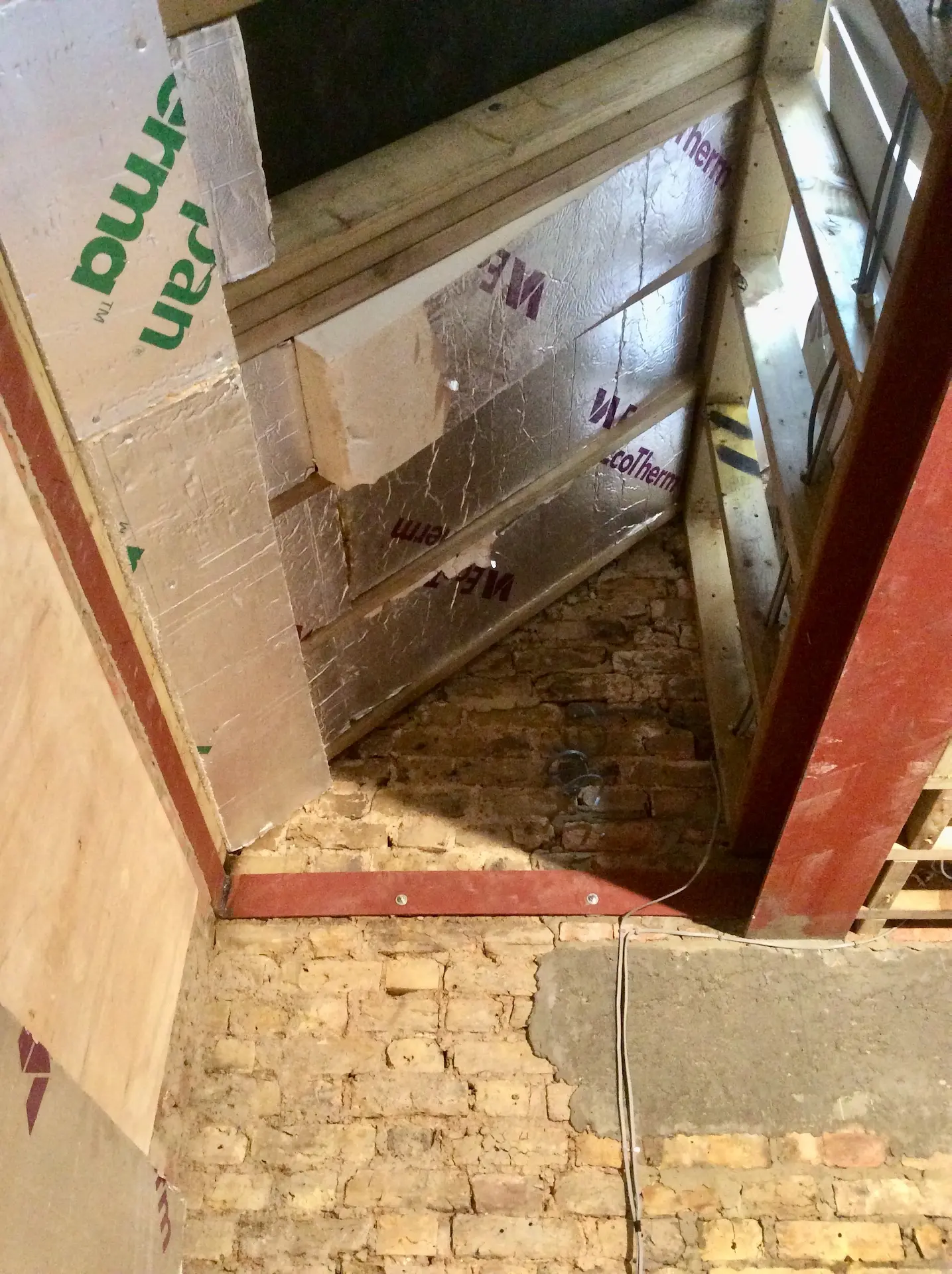 Vaulted ceiling structure with steel beams and timber framework in a west London loft conversion