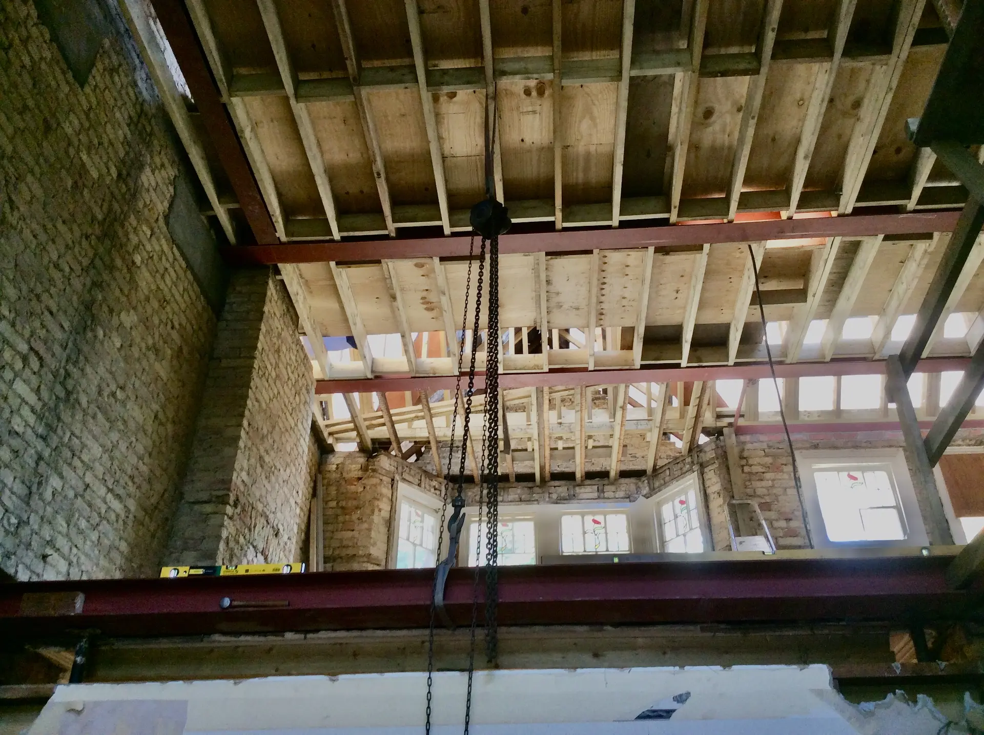 Steel beams and timber floor joists being installed for a loft conversion in Chiswick, London