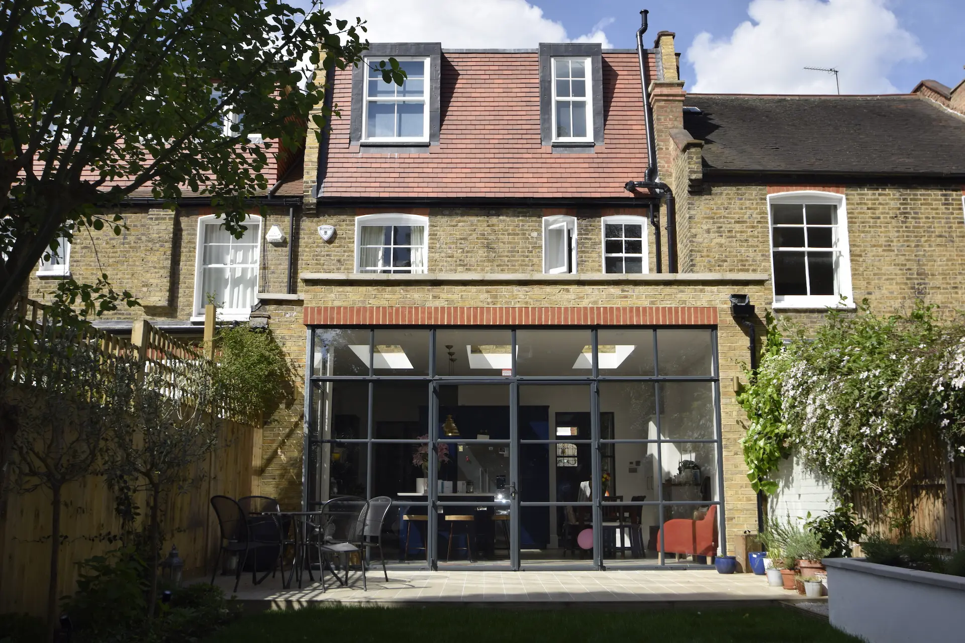 Rear elevation of completed house renovation in Ealing with loft conversion, ground floor extension, and Crittall doors